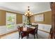 Elegant dining room featuring a wooden table, chandelier lighting, and large windows for natural light at 2841 Landing Dr, Marietta, GA 30066
