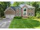 Stately two-story brick home featuring manicured lawn, symmetrical design, and attached two-car garage at 2841 Landing Dr, Marietta, GA 30066