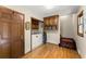 Functional laundry area featuring a washing machine, storage cabinets, and hardwood floors at 2841 Landing Dr, Marietta, GA 30066