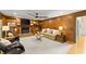 Elegant living room featuring wood paneling, a fireplace, built-in shelving, and ample seating at 2841 Landing Dr, Marietta, GA 30066