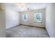 Standard bedroom featuring neutral carpet, windows, and a ceiling fan at 3625 Stonehenge Ne Way, Marietta, GA 30066