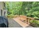 A wooden deck overlooks the serene wooded backyard of the property, creating a peaceful retreat at 3625 Stonehenge Ne Way, Marietta, GA 30066