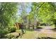 The house showcases a spacious backyard, a wooden deck, and an attached two-car garage at 3625 Stonehenge Ne Way, Marietta, GA 30066