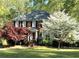 Traditional brick home with mature trees and a well-manicured lawn at 3625 Stonehenge Ne Way, Marietta, GA 30066