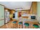 Open eat-in kitchen with wooden bar and stools, stainless refrigerator, and built-in oven at 3625 Stonehenge Ne Way, Marietta, GA 30066