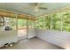Relaxing screened-in porch with a ceiling fan and view of the lush backyard at 3625 Stonehenge Ne Way, Marietta, GA 30066