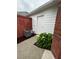 Home's backyard featuring a brick wall, privacy fence, and a well-maintained AC unit at 401 Courtyard Ter, Woodstock, GA 30189