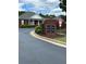 Welcoming entrance to the Courtyards at Towne Lake with well-maintained landscaping and brick signage at 401 Courtyard Ter, Woodstock, GA 30189