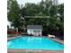 Community pool surrounded by lush trees at 401 Courtyard Ter, Woodstock, GA 30189