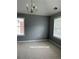 Bright dining room with gray walls, neutral carpet, and large windows providing ample natural light at 401 Courtyard Ter, Woodstock, GA 30189