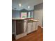 Bright kitchen features stainless steel appliances, wooden floors, and ample cabinet space at 401 Courtyard Ter, Woodstock, GA 30189