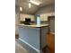 Open-concept kitchen features an island and modern appliances at 401 Courtyard Ter, Woodstock, GA 30189