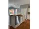 Bright kitchen features stainless steel appliances, wooden floors, and ample cabinet space at 401 Courtyard Ter, Woodstock, GA 30189