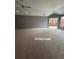 Spacious living room with vaulted ceiling and ample natural light from sliding glass door at 401 Courtyard Ter, Woodstock, GA 30189