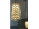 Close-up of kitchen pendant lights with a crystal pattern in glass cylinder at 401 Courtyard Ter, Woodstock, GA 30189