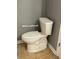 A white standard toilet with tile floors at 401 Courtyard Ter, Woodstock, GA 30189