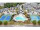 Aerial view of community pool, clubhouse, tennis courts and manicured landscaping at 5365 Radford Loop, Fairburn, GA 30213