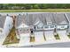 Aerial view of townhomes with garages, manicured lawns, and modern exteriors at 5365 Radford Loop, Fairburn, GA 30213