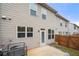 Enclosed backyard featuring concrete patio, door to unit, and wood privacy fence at 5365 Radford Loop, Fairburn, GA 30213
