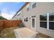 Enclosed backyard with concrete patio and a wood privacy fence at 5365 Radford Loop, Fairburn, GA 30213