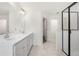 Bright bathroom with double sink vanity, marble floors, and a glass enclosed shower at 5365 Radford Loop, Fairburn, GA 30213