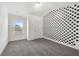 Bright bedroom featuring modern gray carpet, a window, and a playful polka dot accent wall at 5365 Radford Loop, Fairburn, GA 30213