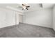 Spacious bedroom with tray ceiling, fan, plush gray carpet, and ample natural light at 5365 Radford Loop, Fairburn, GA 30213