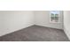 Simple bedroom with gray carpet, window, and white trim, ready for personalization at 5365 Radford Loop, Fairburn, GA 30213