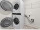 Convenient laundry area featuring a stacked washer and dryer set and wire rack shelving at 5365 Radford Loop, Fairburn, GA 30213