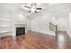 Bright living room with fireplace, recessed lights, and staircase to upper level at 5365 Radford Loop, Fairburn, GA 30213