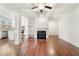 Open-concept living room with coffered ceiling and stone fireplace at 5365 Radford Loop, Fairburn, GA 30213