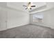 Bright main bedroom featuring a tray ceiling, fan, neutral walls and carpet at 5365 Radford Loop, Fairburn, GA 30213