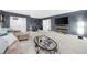Spacious basement with comfortable furnishings, TV, and exercise equipment at 8555 Hope Mews Ct, Sandy Springs, GA 30350