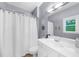 Bathroom featuring a shower with curtain and a white vanity sink with plenty of counter space at 8555 Hope Mews Ct, Sandy Springs, GA 30350