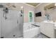 Bathroom with a glass-enclosed shower, garden tub, and large window that provides natural light at 8555 Hope Mews Ct, Sandy Springs, GA 30350