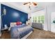 Bright bedroom with blue accent wall, large window, and gray dresser providing ample storage at 8555 Hope Mews Ct, Sandy Springs, GA 30350