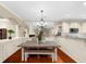 Cozy dining area with hardwood floors, elegant chandelier, and open kitchen access at 8555 Hope Mews Ct, Sandy Springs, GA 30350