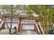 Inviting townhome exterior with brick facade, drive-under garage, and private balconies at 8555 Hope Mews Ct, Sandy Springs, GA 30350