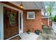 Charming front entrance featuring a wooden door with wreath and brick surround at 8555 Hope Mews Ct, Sandy Springs, GA 30350
