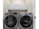 Well-equipped laundry room features front-load washer and dryer, plus storage cabinets at 8555 Hope Mews Ct, Sandy Springs, GA 30350