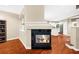 Cozy living room with hardwood floors, a fireplace, and a view into the modern kitchen at 8555 Hope Mews Ct, Sandy Springs, GA 30350