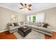 Inviting living room with a large sectional sofa, hardwood floors, and a ceiling fan at 8555 Hope Mews Ct, Sandy Springs, GA 30350
