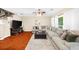 Bright living room with hardwood floors, a large sectional sofa, and a ceiling fan at 8555 Hope Mews Ct, Sandy Springs, GA 30350