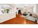 Open-concept living room showcasing hardwood floors, a large sectional sofa, and seamless transitions to the kitchen at 8555 Hope Mews Ct, Sandy Springs, GA 30350