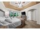 This comfortable main bedroom includes large windows, a TV, and access to ensuite bathroom at 8555 Hope Mews Ct, Sandy Springs, GA 30350