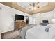 Spacious main bedroom features a tray ceiling, ceiling fan, and an ensuite bathroom at 8555 Hope Mews Ct, Sandy Springs, GA 30350