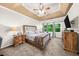 Spacious main bedroom featuring tray ceilings, carpeted floors, and large windows at 8555 Hope Mews Ct, Sandy Springs, GA 30350