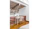 Bedroom detail highlighting the desk area, exposed ceiling, and hardwood floors in a modern and airy space at 964 Dekalb Ne Ave # 112, Atlanta, GA 30307