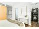 Bedroom featuring a sliding barn door and a stackable washer/dryer at 964 Dekalb Ne Ave # 112, Atlanta, GA 30307
