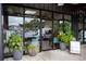 Exterior salon front with glass windows, sign postings, lush greenery, and parking spaces at 964 Dekalb Ne Ave # 112, Atlanta, GA 30307